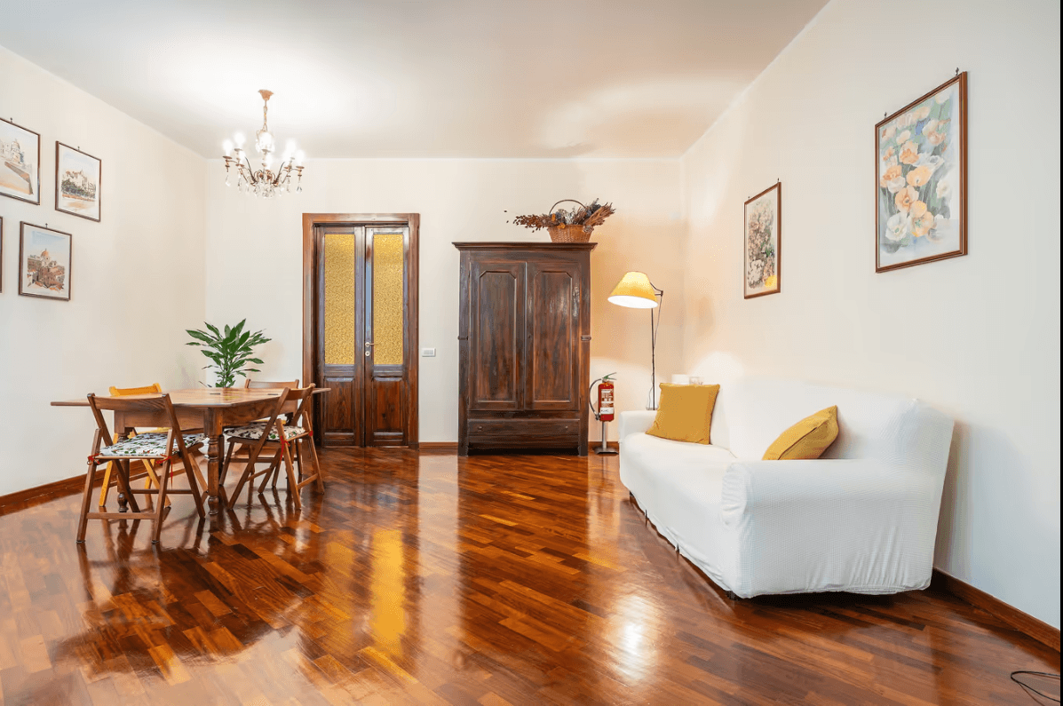 Living room with dining table and sofa at ĀMĪTA